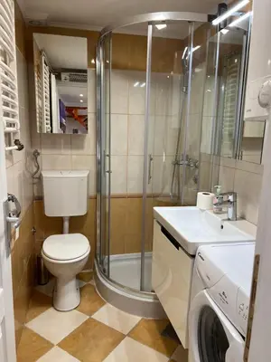 a bathroom with a shower and a toilet and a sink at Silicon Valley studio in Belgrade