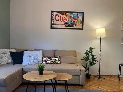 a living room with a couch and a table at Under the Pine in Belgrade
