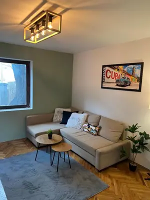 a living room with a couch and a table at Under the Pine in Belgrade