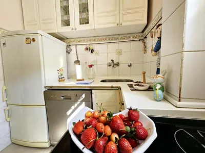 a kitchen with a bowl of strawberries on the counter at Apartman Didi in Belgrade