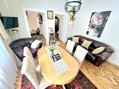 a living room with a table and leather furniture at Apartman Didi in Belgrade