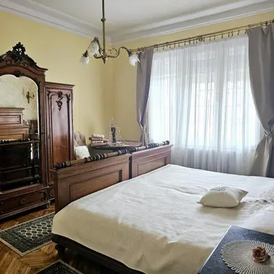 a bedroom with a bed and a dresser and a window at Apartman Didi in Belgrade