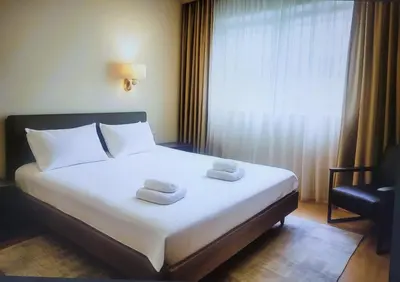 a hotel room with a bed with two towels on it at Apartman Beograd Banovo Brdo - lux dvosoban stan in Belgrade