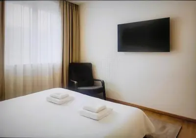 a hotel room with a bed with two towels on it at Apartman Beograd Banovo Brdo - lux dvosoban stan in Belgrade
