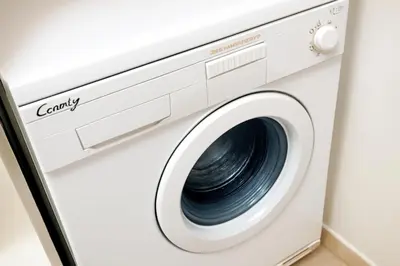 a white washer and dryer in a room at Apartman Beograd Banovo Brdo - lux dvosoban stan in Belgrade