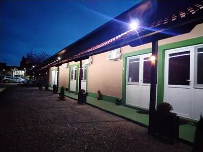 a row of buildings at night with lights on them at FUN ROOMS SOBE PRENOĆIŠTE in Borča