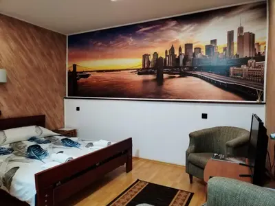 a bedroom with a large painting on the wall at FUN ROOMS SOBE PRENOĆIŠTE in Borča