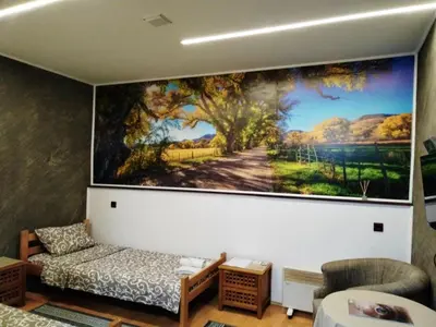 a living room with a large painting on the wall at FUN ROOMS SOBE PRENOĆIŠTE in Borča