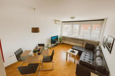 a living room with a couch and a table at ART residence Cara Urosa in Belgrade