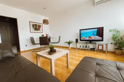 a living room with a couch and a tv at ART residence Cara Urosa in Belgrade