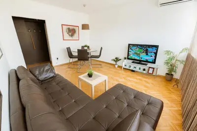 a living room with a couch and a tv at ART residence Cara Urosa in Belgrade