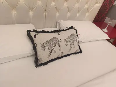 a white bed with a pillow with a horse on it at TITO in Belgrade