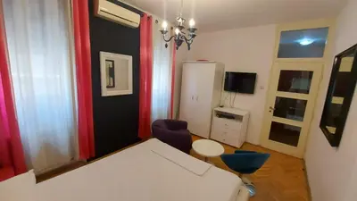 a living room with a white couch and a refrigerator at TITO in Belgrade