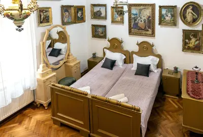 a bedroom with a large bed and a large mirror at Natalie's Gallery in Belgrade