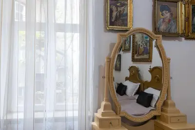 a mirror on a wall next to a window at Natalie's Gallery in Belgrade