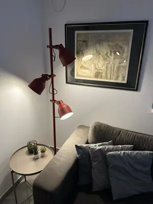 a living room with a couch and a table with a lamp at Apartman u Zemunu in Zemun