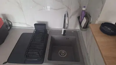 a kitchen counter with a sink and a sink at Apartman u Zemunu in Zemun