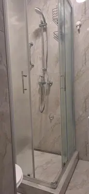 a shower with a glass door in a bathroom at Apartman u Zemunu in Zemun