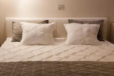 a white bed with two pillows at Athens Apartment City Center in Belgrade
