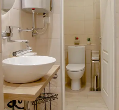 a bathroom with a white sink and a toilet at Athens Apartment City Center in Belgrade