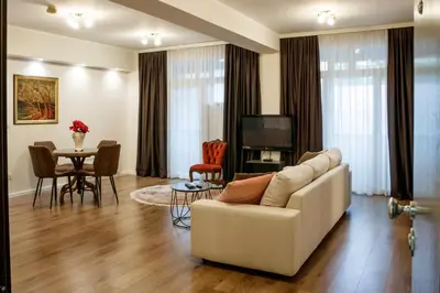 a living room with a white couch and a table at Athens Apartment City Center in Belgrade