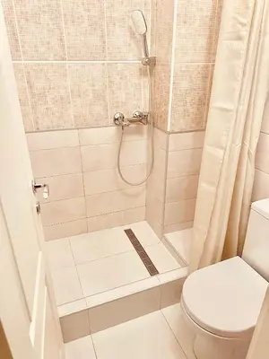 a bathroom with a shower with a toilet at Athens Apartment City Center in Belgrade