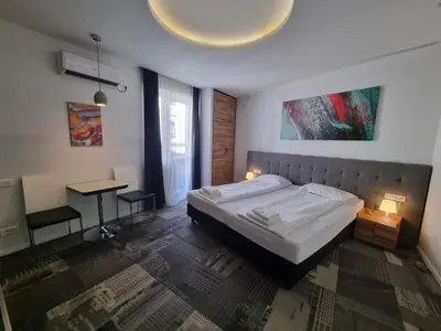 a bedroom with a bed and a desk in it at Decanska Apartments in Belgrade