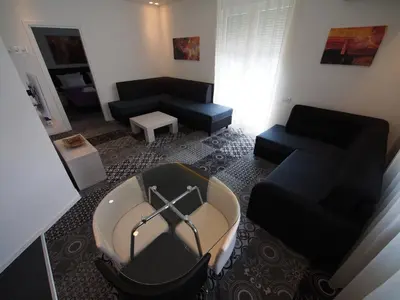 a living room with a couch and a chair at Decanska Apartments in Belgrade