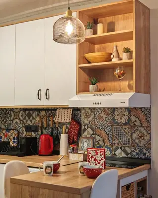 a kitchen with white cabinets and a wooden table at Azulejo Apartment in Novi Beograd