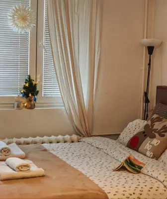 a bedroom with a bed with towels on it at Azulejo Apartment in Novi Beograd