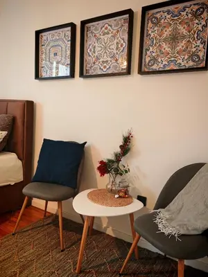 a living room with two chairs and a table at Azulejo Apartment in Novi Beograd