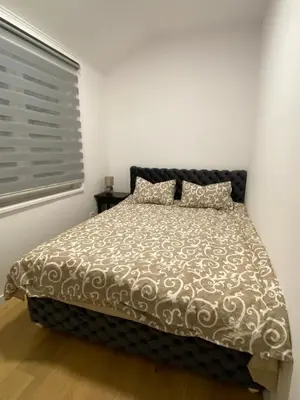 a bedroom with a bed in a room with a window at Filmski grad Apartmani in Filmski Grad