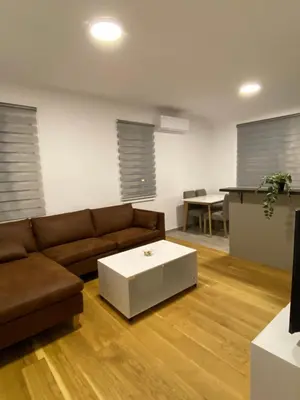 a living room with a couch and a table at Filmski grad Apartmani in Filmski Grad