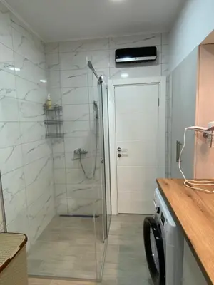 a shower with a glass door in a bathroom at Filmski grad Apartmani in Filmski Grad