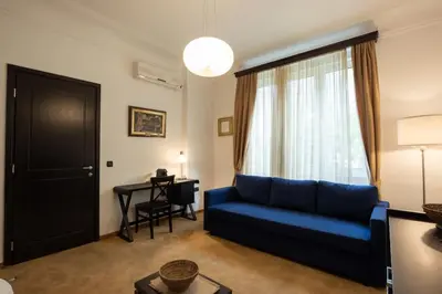 a living room with a blue couch and a table at Belgrade Center Apartment Lux V in Belgrade