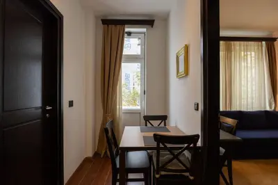 a living room with a dining room table and a couch at Belgrade Center Apartment Lux V in Belgrade