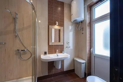 a bathroom with a sink and a glass shower at Belgrade Center Apartment Lux V in Belgrade