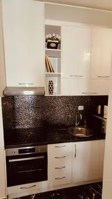 a kitchen with white cabinets and a sink at Top Republic in Belgrade