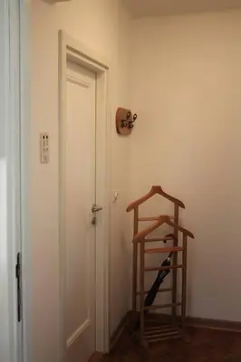 a room with a wooden ladder next to a door at Cozy with parking in Zemun