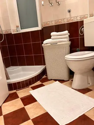 a bathroom with a toilet and a tub and a sink at Cozy with parking in Zemun