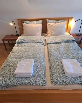 two beds with white pillows on them in a room at Apartman 2001 Stari grad in Belgrade