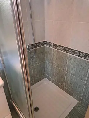 a shower with a glass door in a bathroom at Apartman 2001 Stari grad in Belgrade