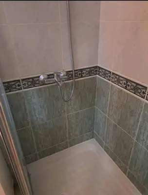 a shower with a hose in a bathroom at Apartman 2001 Stari grad in Belgrade