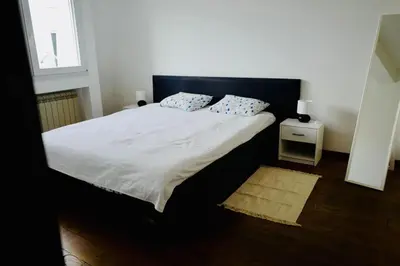 a bed with two pillows on it in a bedroom at Apartment Norman Bates in Belgrade