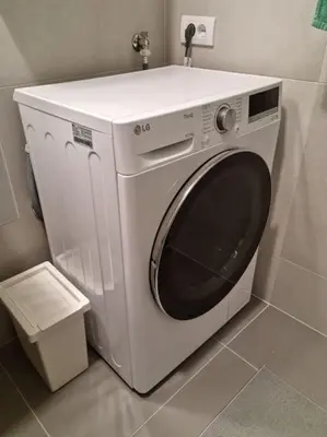 a white washing machine sitting in a bathroom at Apartment Norman Bates in Belgrade