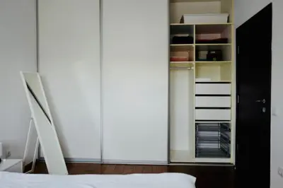 a bedroom with a bed and a closet at Apartment Norman Bates in Belgrade