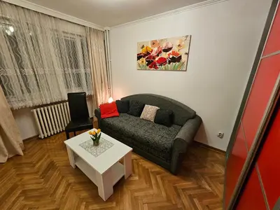 a living room with a couch and a table at Slavija Apartment in Belgrade
