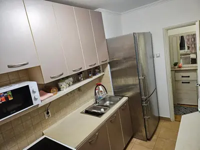 a kitchen with a sink and a refrigerator at Slavija Apartment in Belgrade