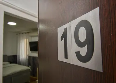 a door with a house number sign on it at Studio Sky in Belgrade