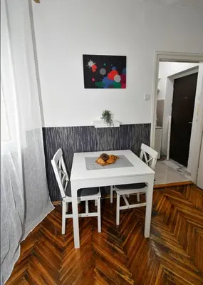 a white table and two chairs in a room at Studio Sky in Belgrade
